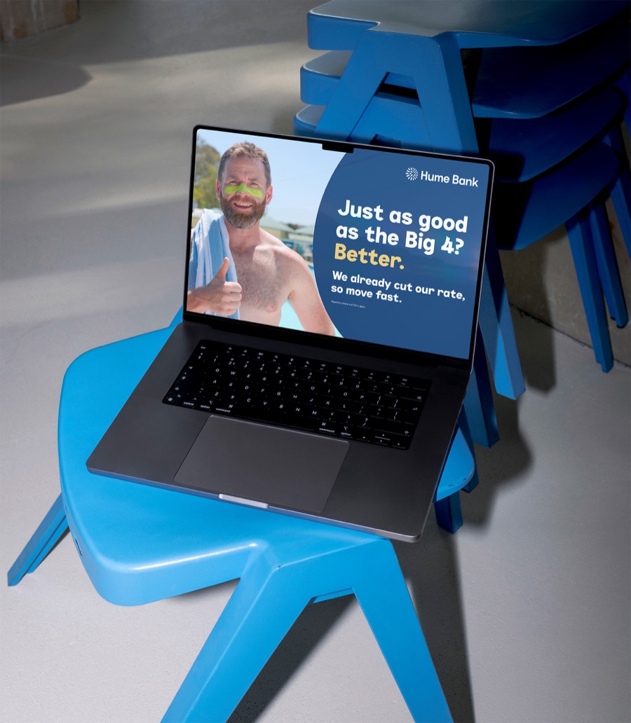 Laptop on a blue chair showing a Hume Bank campaign page