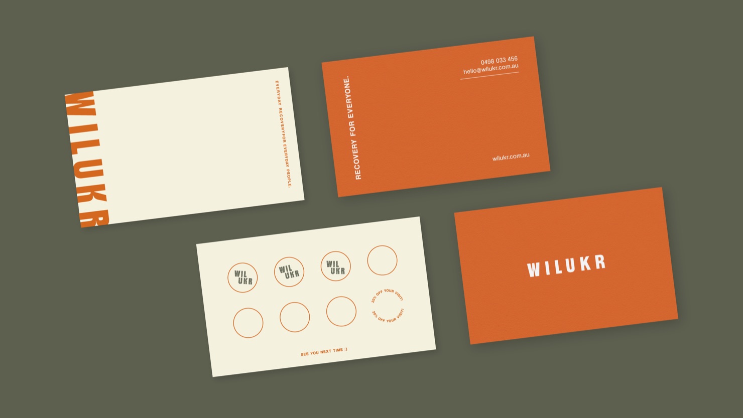 Wilukr business and loyalty cards in orange and cream laid out on an olive background